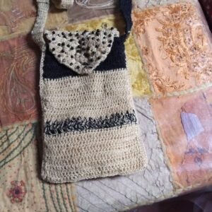 crossbody bag in a natural beigecream tone with black accents