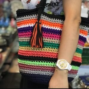 Close-up lifestyle shot featuring a vibrant multicolored crochet bucket bag